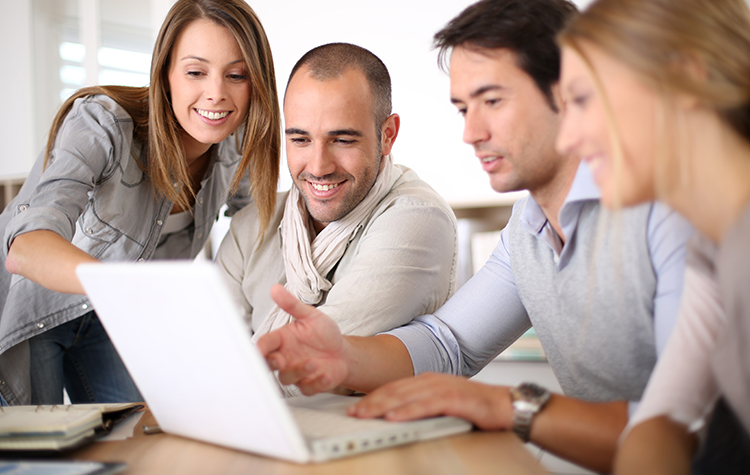 Payroll team in a meeting at a computer