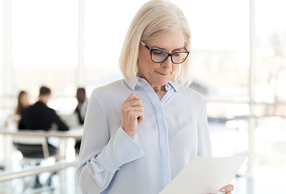 woman reading a paper